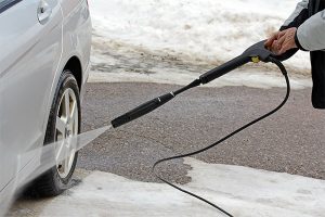 Washing car to help prevent rust.
