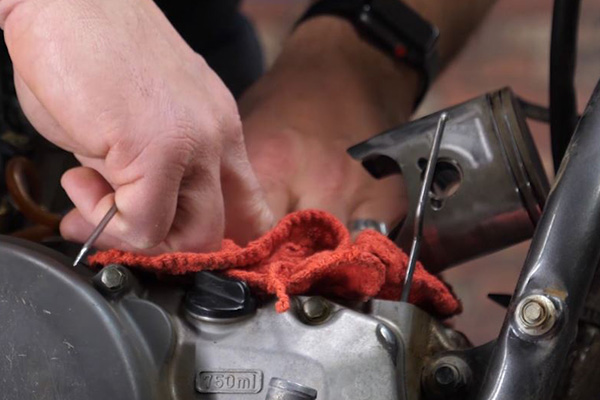 Two-stroke dirt bike top-end rebuild, removing the piston.