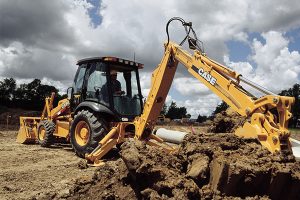 Backhoe digging up ground. 
