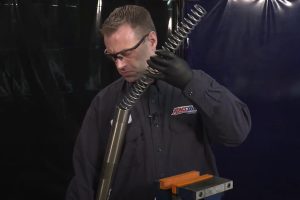 Install dirt bike spring in fork tube.