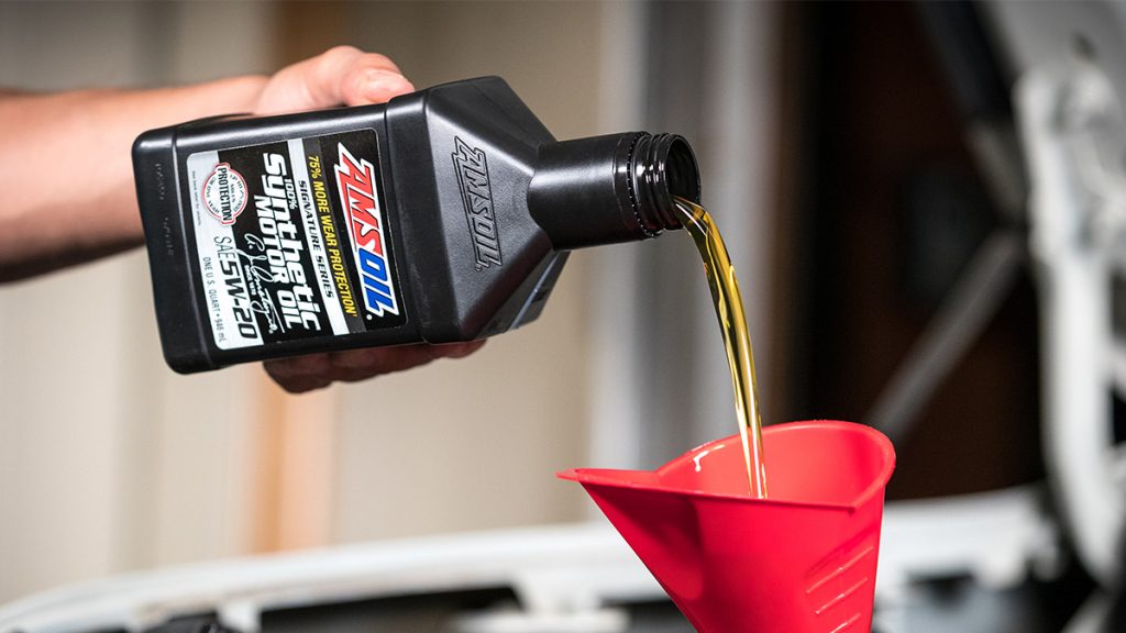 AMSOIL Signature Series 100% Synthetic Motor Oil is poured into an engine.