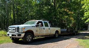 Commercial pickup truck tows heavy equipment. 